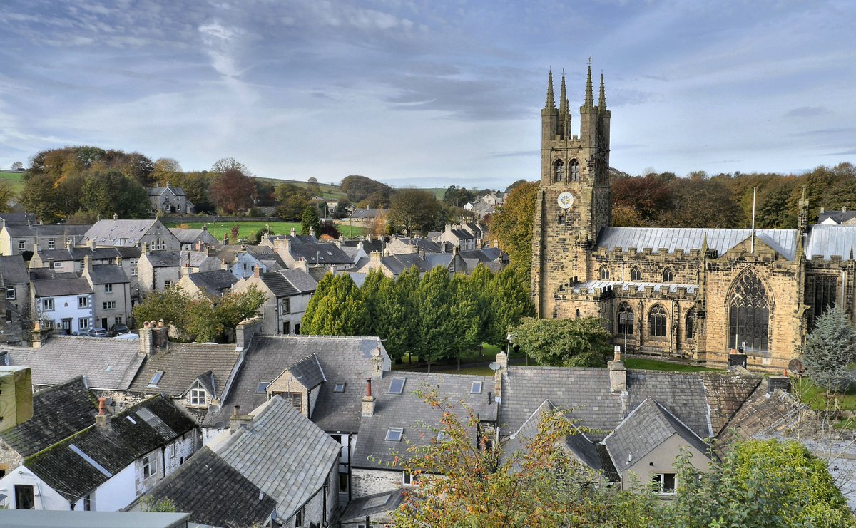 Panoramic view over Tideswell village rooftops towards the Cathedral of the Peak
